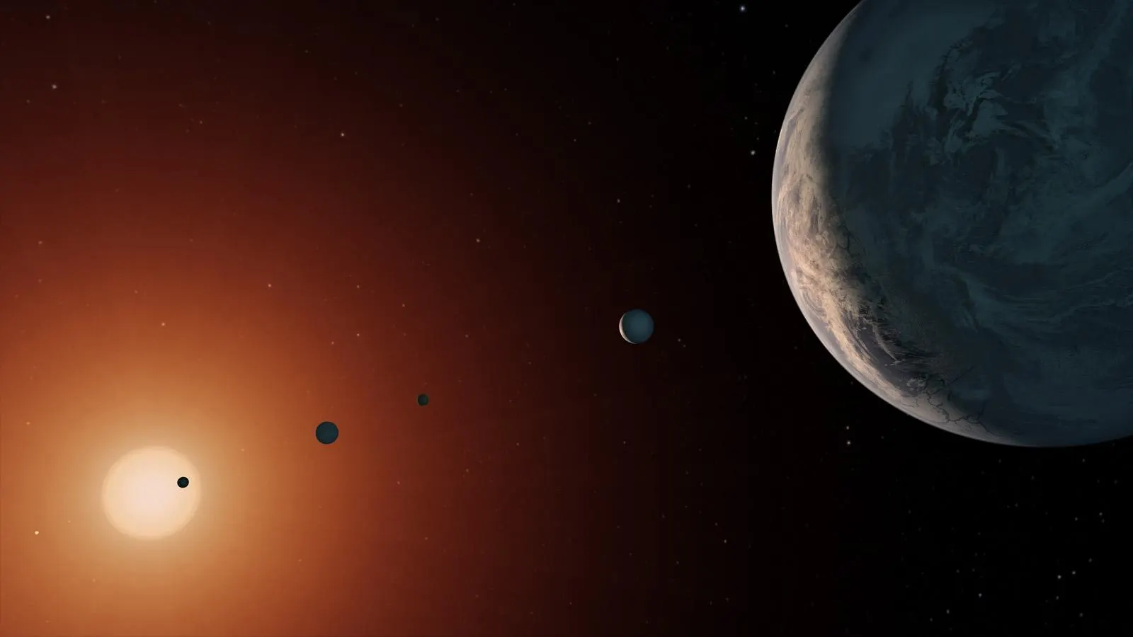 Artist's concept of seven rocky planets in a line in front of a small, dim red star