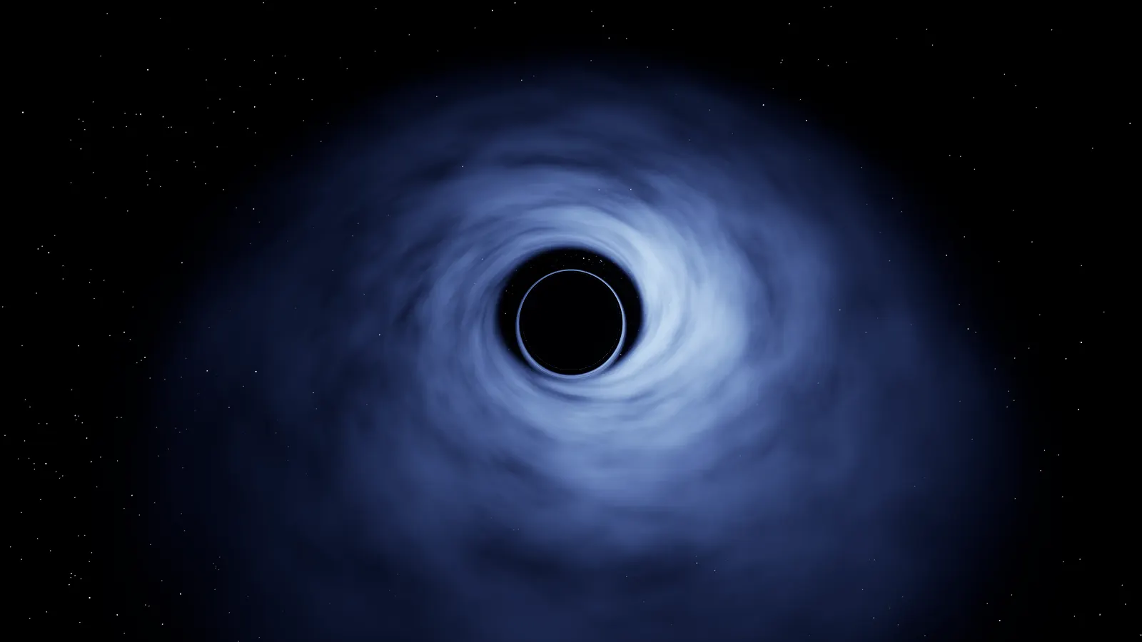 A black circle ringed by a thin bright line at the centre of a broad swirl of blue-white gas seen from well above the disk, with stars on a black background.