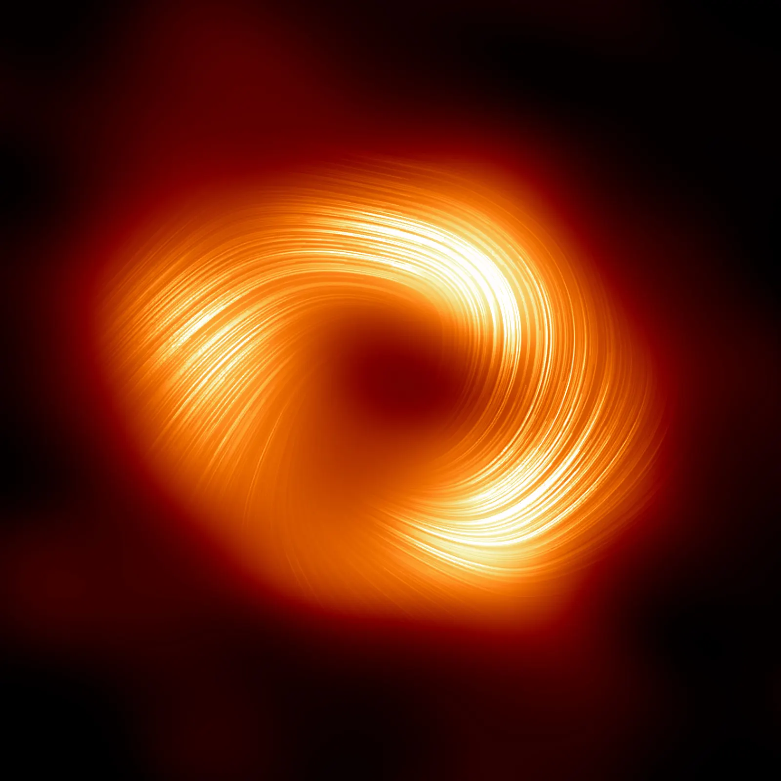 The orange ring of Sagittarius A* overlaid with fine curved lines that spiral around the dark centre.