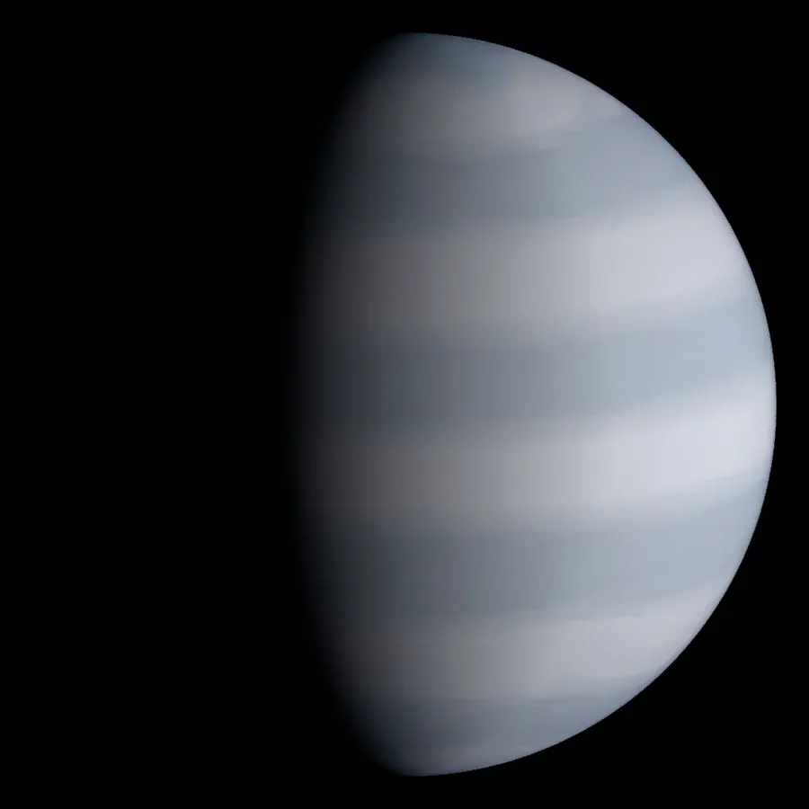 A white gas giant with pale blue bands, lit from the right, its left side in shadow.