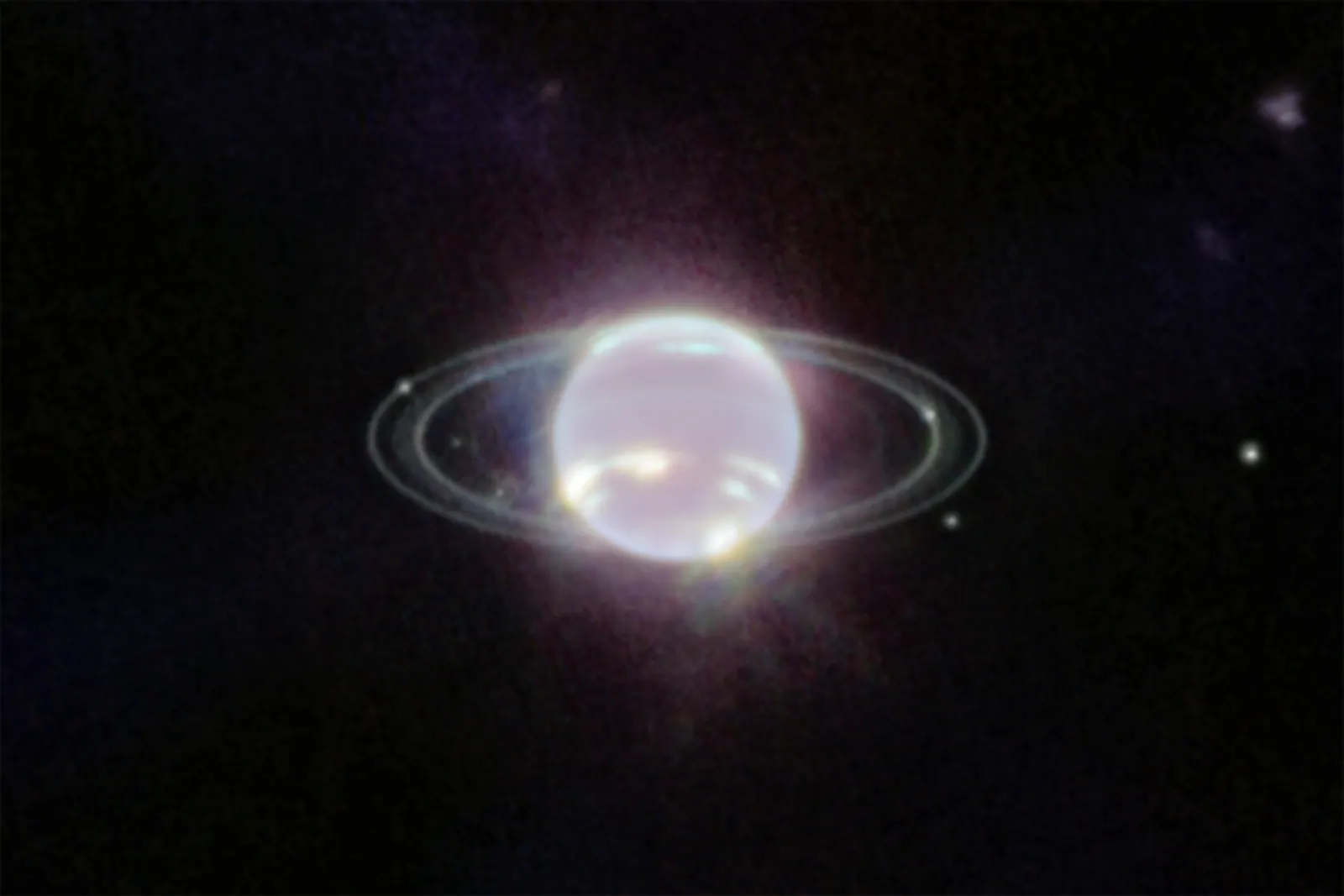 Neptune in near-infrared light, a dim disc ringed by thin bright rings, with bright clouds in its southern hemisphere