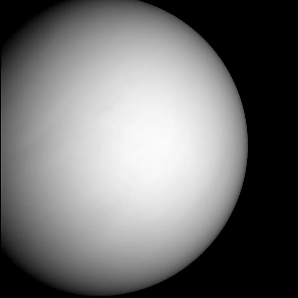 A smooth, almost featureless pale disc lit from one side against black space.