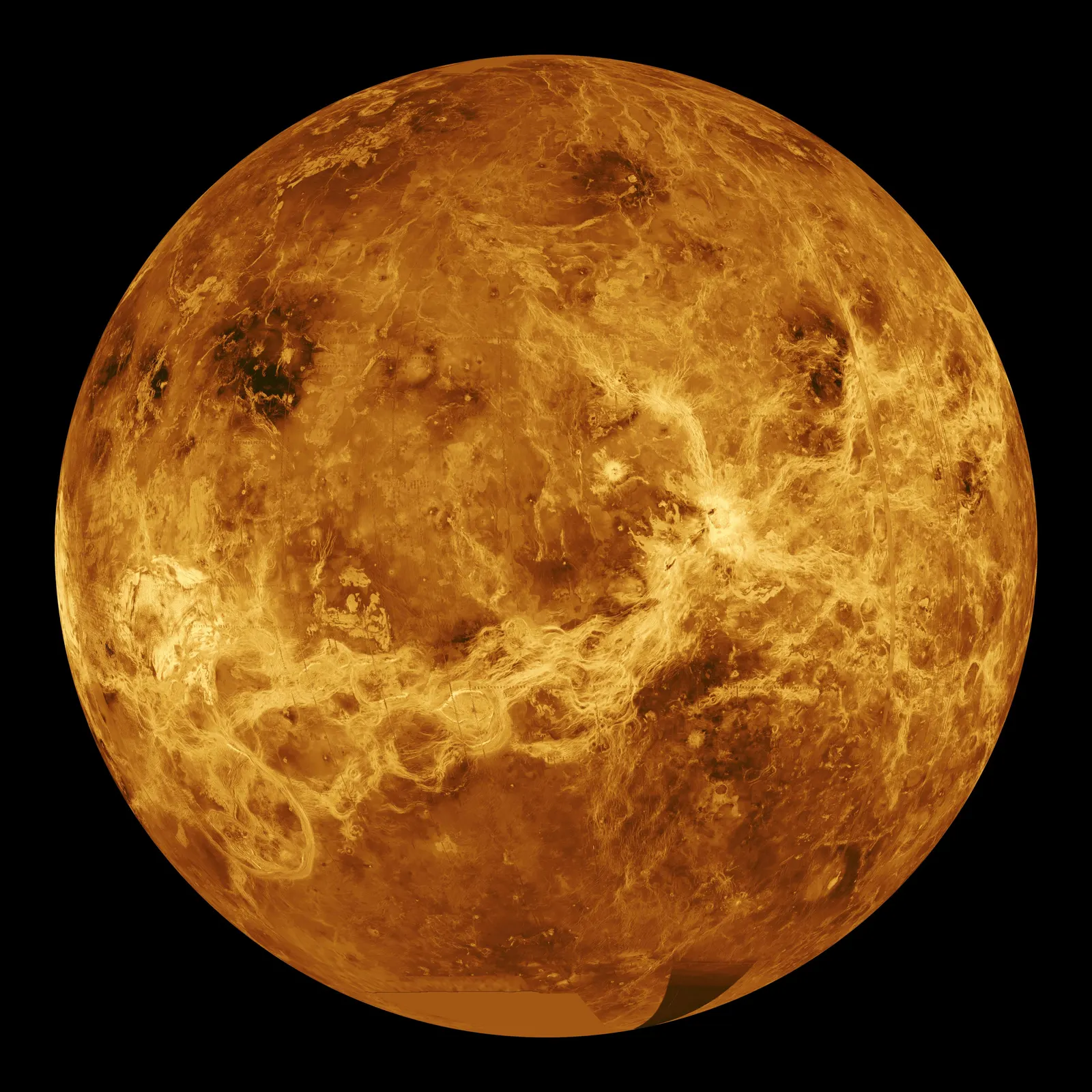 A globe in orange and brown tones showing volcanic plains, bright highland regions and fracture belts.